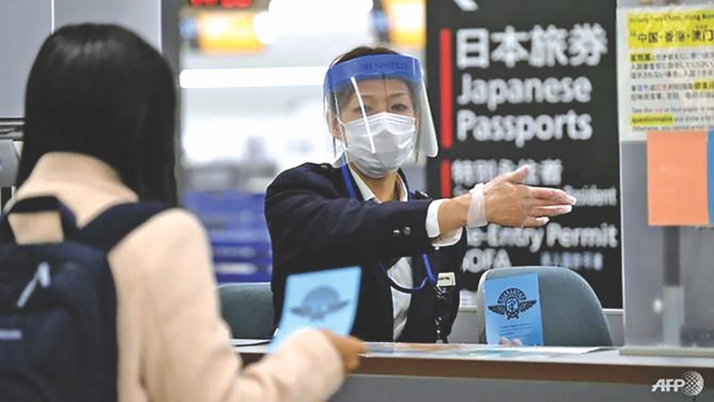 Japan politician apologises for auctioning face masks