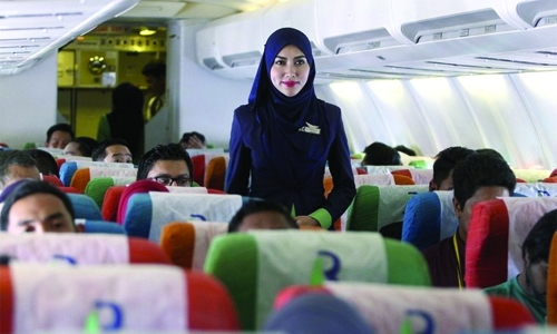 Malaysia's Islamic airline takes off with a prayer, halal meals, dress code for attendants