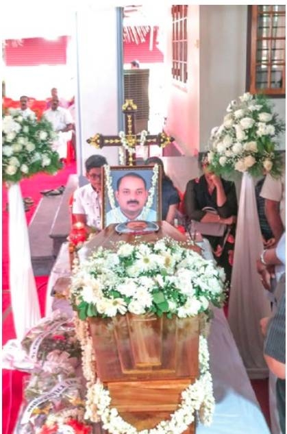 Remains of expat buried, four months after death