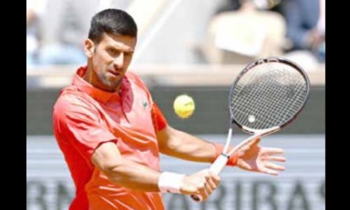 Djokovic battles into French Open second round