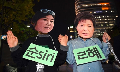 Raids, protests pressure S. Korea's scandal-hit president