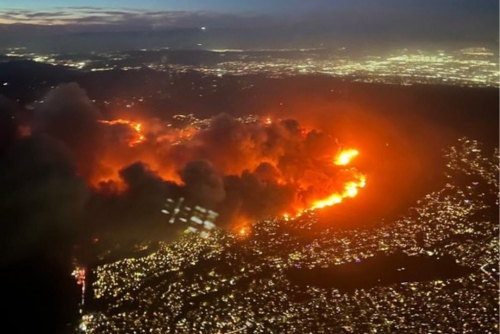 Wildfire Rages Through Los Angeles Suburb, Forcing Thousands to Flee