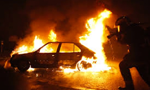 Bahrain jails three for torching cars  