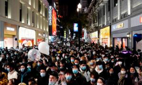 Crowds fill streets in China's pandemic-hit Wuhan for New Year