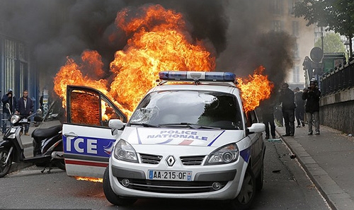 Four charged with attempted murder after police car torched in France