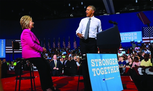 Obama says ready to 'pass the baton' to Clinton