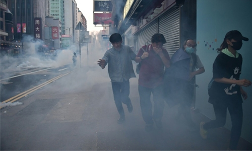 Tear gas, water cannon as crowds defy HK ban