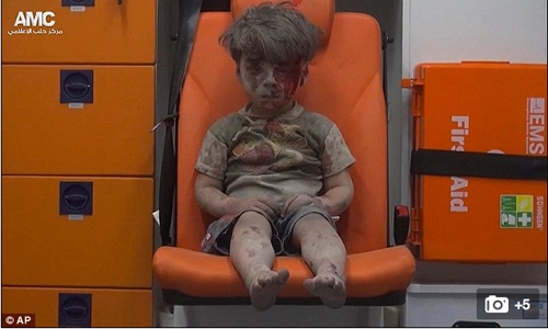 Heartbreaking moment  injured boy sits alone after deadly Syrian airstrike 